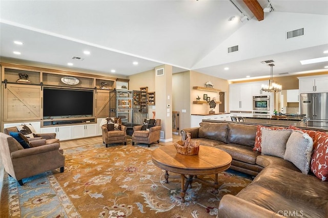living area with an inviting chandelier, visible vents, light wood finished floors, and beam ceiling