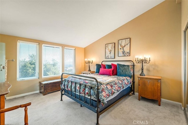 carpeted bedroom with lofted ceiling