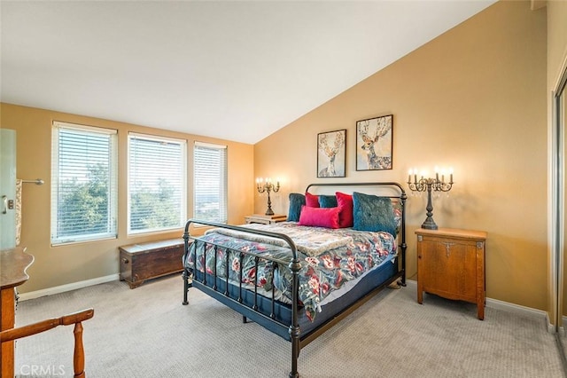 bedroom featuring baseboards, lofted ceiling, and carpet floors