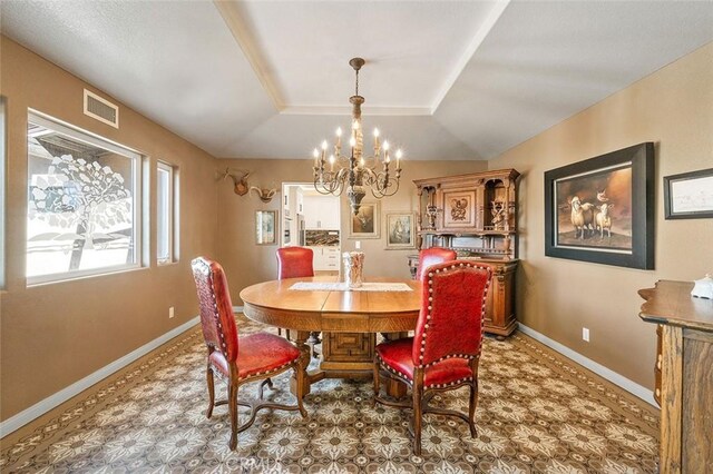 dining room featuring a raised ceiling, lofted ceiling, and a notable chandelier