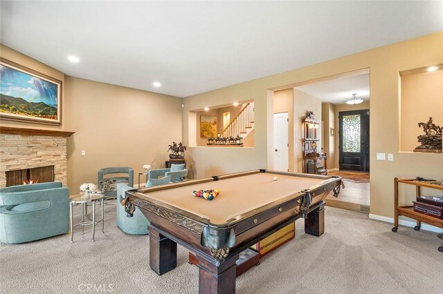 recreation room with light colored carpet, a fireplace, and pool table