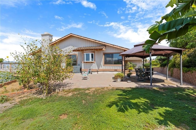 back of house with a gazebo, a yard, and a patio