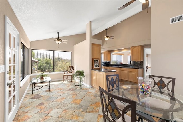 dining room with a wealth of natural light and high vaulted ceiling