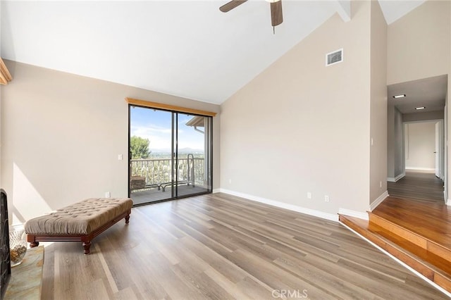 interior space with hardwood / wood-style flooring, ceiling fan, and high vaulted ceiling