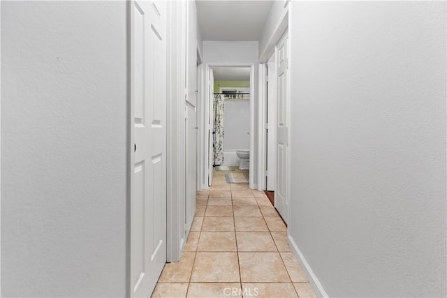 hallway featuring light tile patterned floors