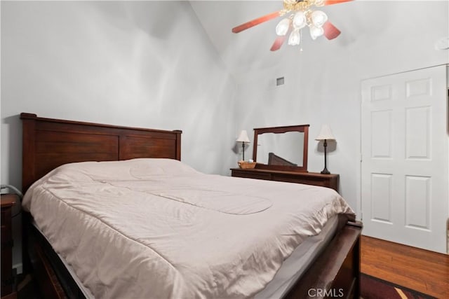 bedroom with hardwood / wood-style flooring, ceiling fan, and lofted ceiling