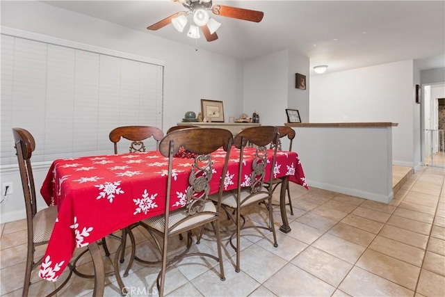 tiled dining space featuring ceiling fan