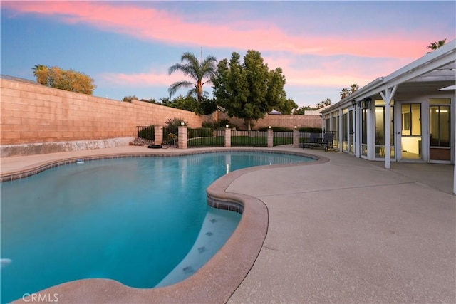 pool at dusk with a patio