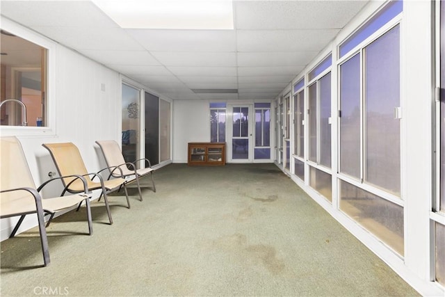 unfurnished sunroom with a drop ceiling and sink