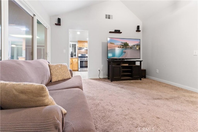 living room with light carpet and high vaulted ceiling