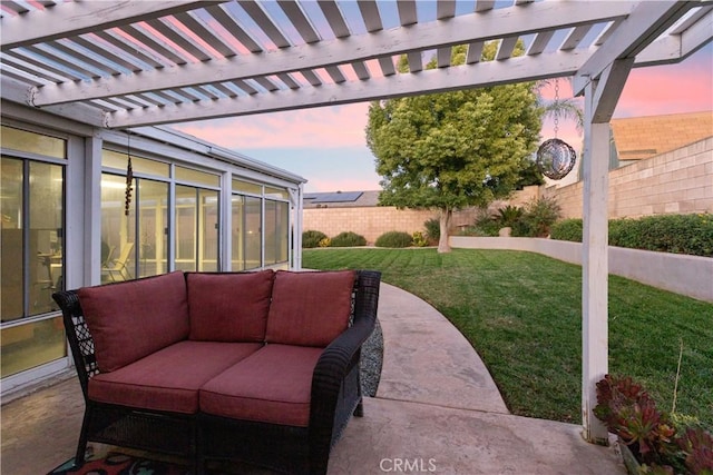 patio terrace at dusk featuring a yard and a pergola