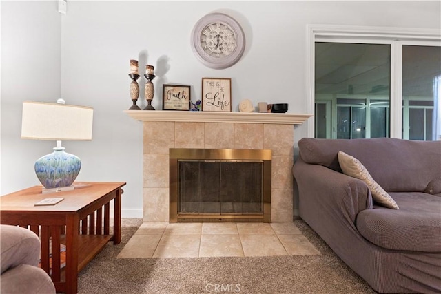 carpeted living room featuring a tiled fireplace