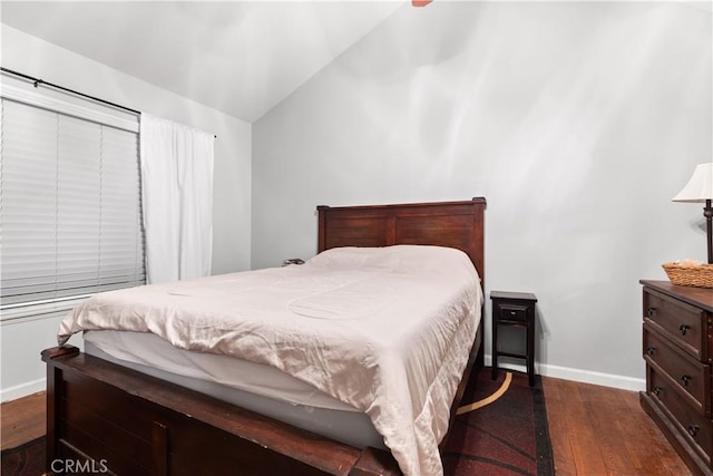 bedroom featuring dark wood-type flooring and vaulted ceiling