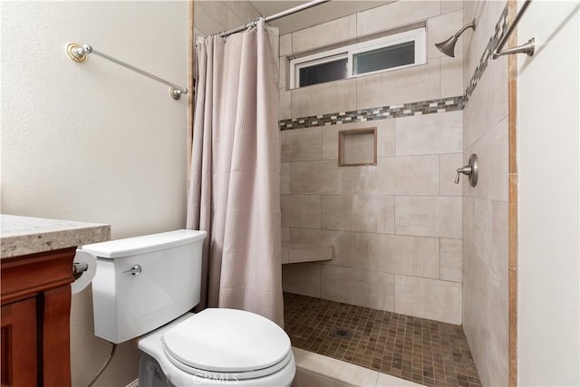 bathroom with walk in shower, vanity, and toilet