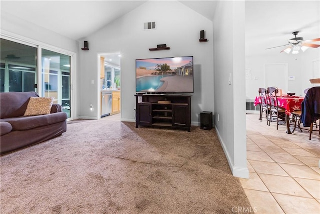 carpeted living room featuring ceiling fan and high vaulted ceiling