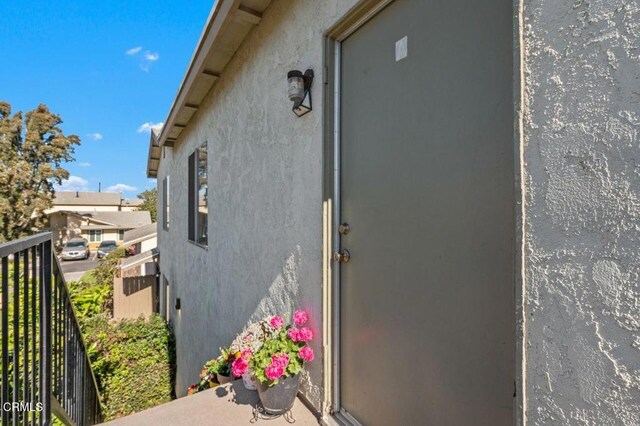1431 Casa San Carlos Ln Unit A, Oxnard, CA 93033 - property entrance featuring stucco siding and a balcony