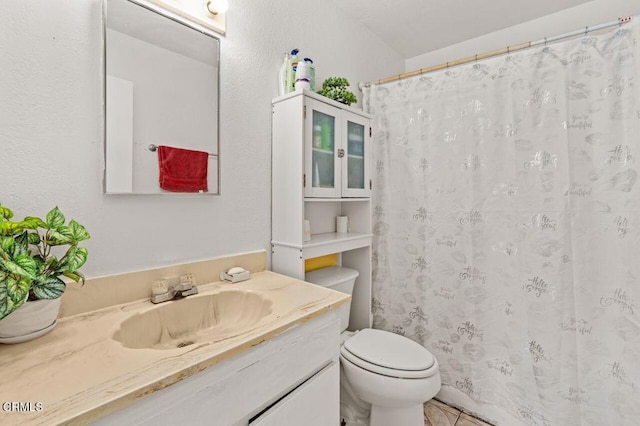 bathroom with tile patterned flooring, vanity, toilet, and a shower with shower curtain