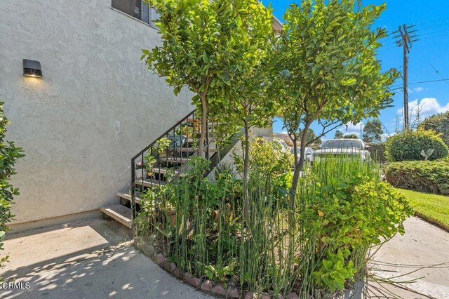 1431 Casa San Carlos Ln Unit A, Oxnard, CA 93033 - view of property exterior featuring stucco siding and stairs