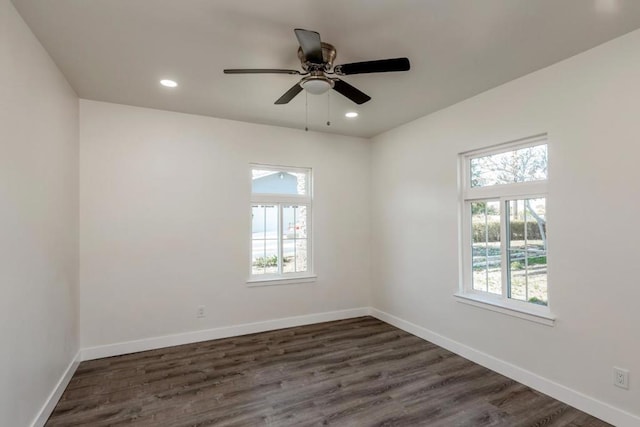 spare room with ceiling fan and dark hardwood / wood-style floors