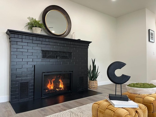 room details with a fireplace and hardwood / wood-style flooring