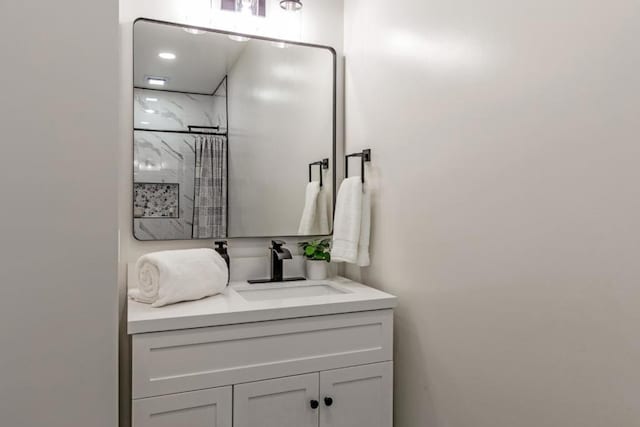 bathroom featuring a shower and vanity