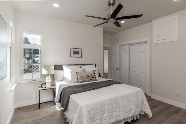 bedroom with hardwood / wood-style floors, a closet, and ceiling fan