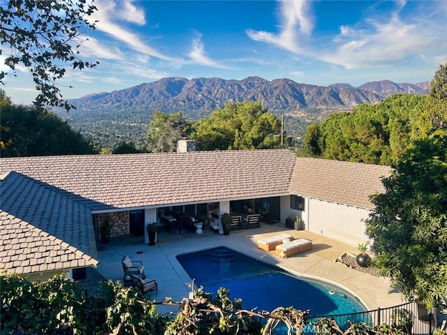 view of pool with a mountain view and a patio