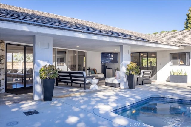 rear view of property featuring an outdoor hangout area and a patio