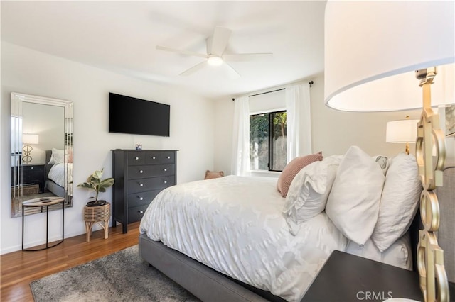 bedroom featuring ceiling fan and dark hardwood / wood-style flooring