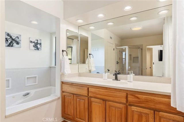 bathroom with vanity and separate shower and tub