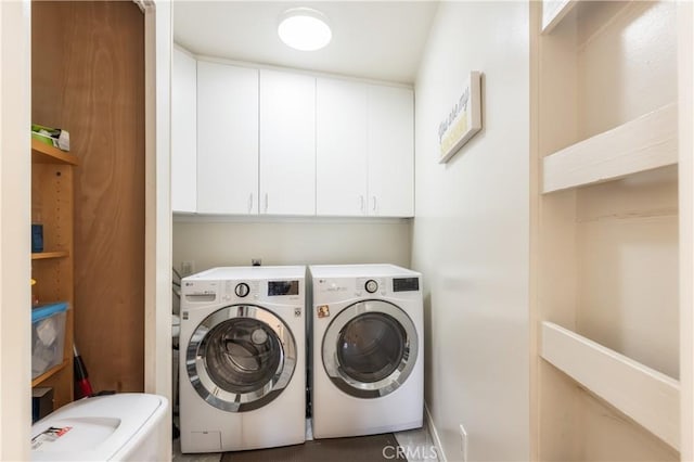 laundry area with washer and dryer and cabinets