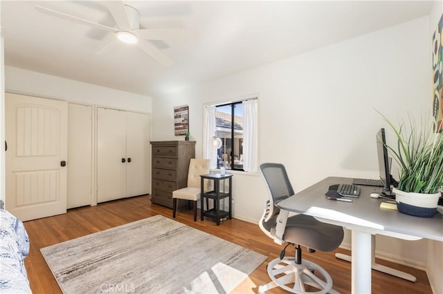 office with ceiling fan and light hardwood / wood-style floors