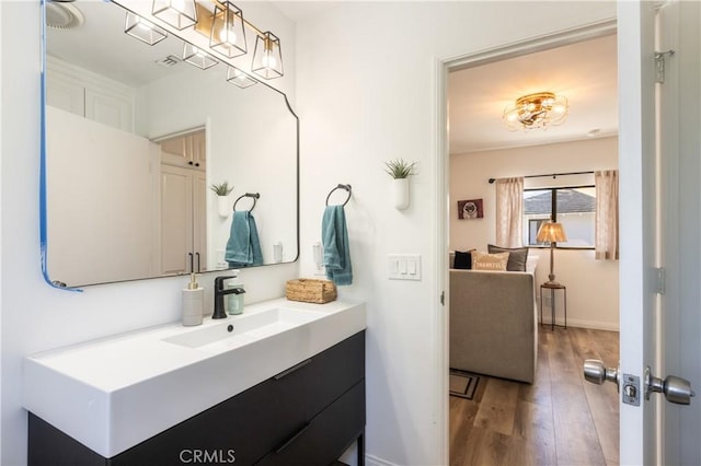 bathroom with vanity and wood-type flooring