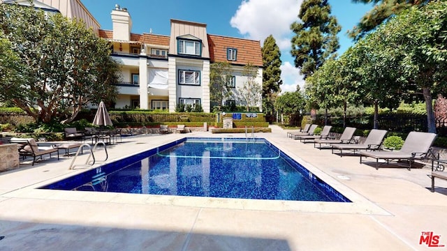 view of swimming pool featuring a patio area