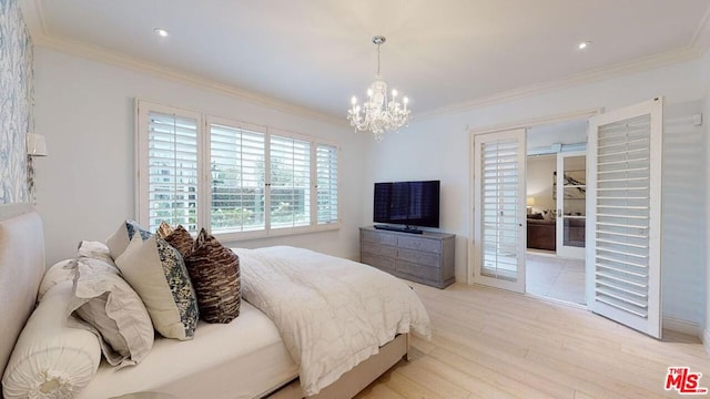 bedroom with light hardwood / wood-style floors, ornamental molding, and a chandelier