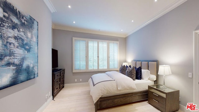 bedroom featuring crown molding and light hardwood / wood-style flooring