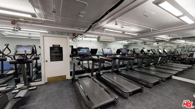 exercise room with a wall mounted AC