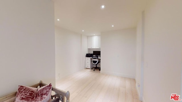 corridor with light hardwood / wood-style flooring