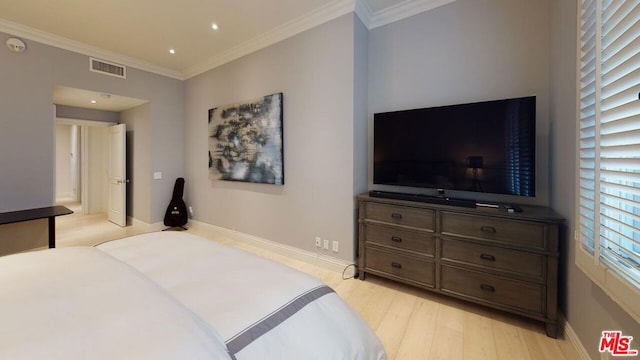 bedroom featuring crown molding and light hardwood / wood-style floors