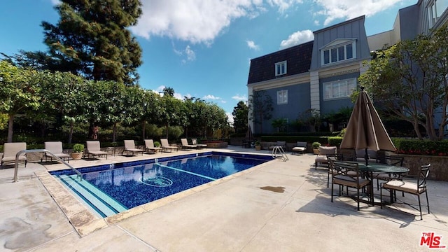 view of pool featuring a patio