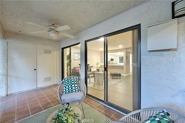 interior space featuring visible vents and a ceiling fan