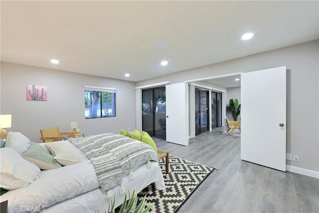 bedroom with access to exterior, recessed lighting, light wood-style flooring, and baseboards