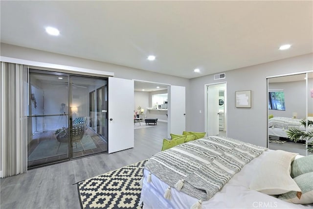 bedroom with visible vents, wood finished floors, and recessed lighting