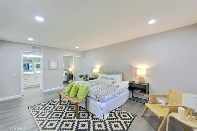 bedroom with recessed lighting, visible vents, baseboards, and wood finished floors