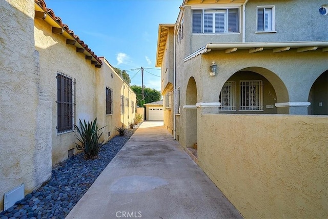 view of side of property featuring a garage and an outbuilding