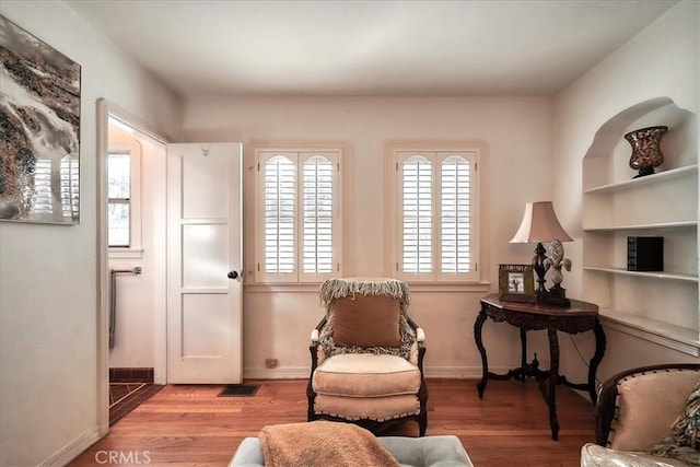 sitting room with hardwood / wood-style flooring