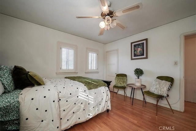 bedroom with hardwood / wood-style floors and ceiling fan