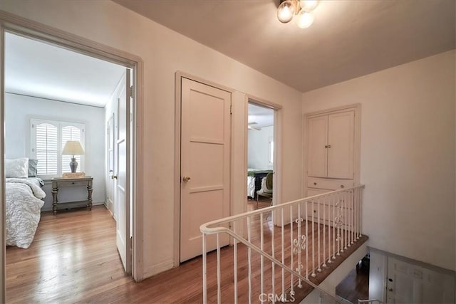 hallway with light hardwood / wood-style floors