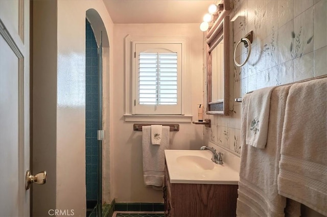 bathroom with vanity and a shower with shower door