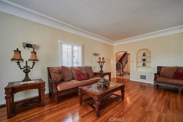 living room with ornamental molding and hardwood / wood-style flooring